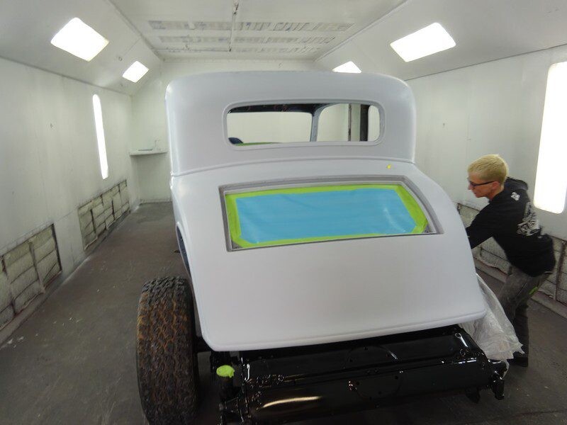 White classic car in paint booth.