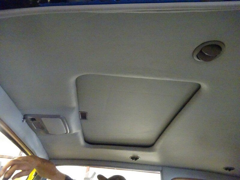 Car interior sunroof overhead view.