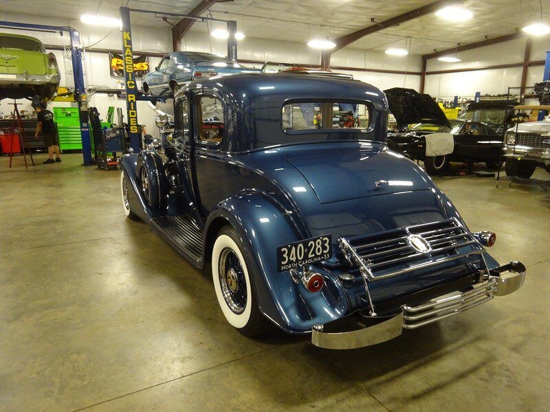Blue vintage car in garage, North Carolina plate.