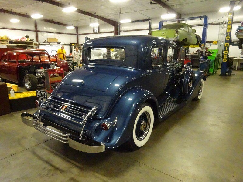 Dark blue classic car in garage.