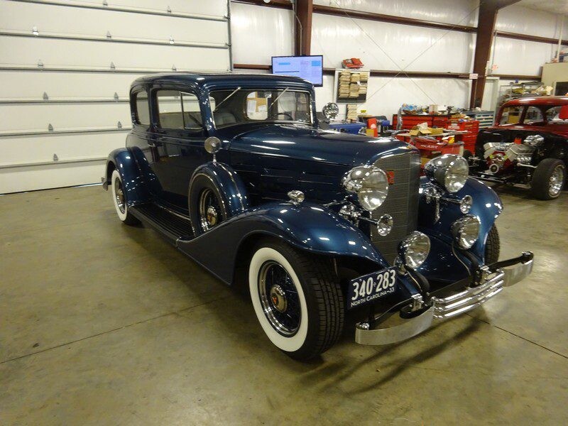 Here's an alt tag for the image: Blue 1934 Cadillac coupe, vintage car.