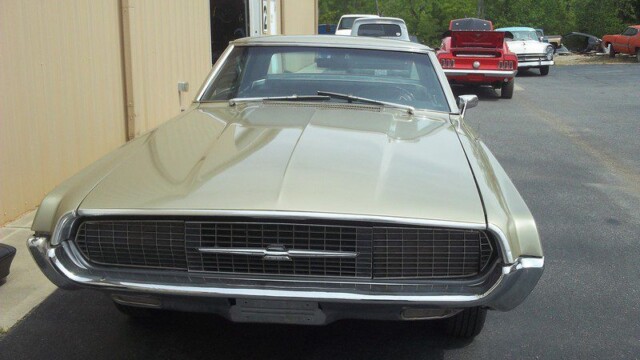 Classic tan Ford Torino in parking lot.