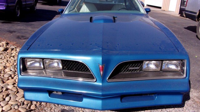 Blue Pontiac Trans Am front view.