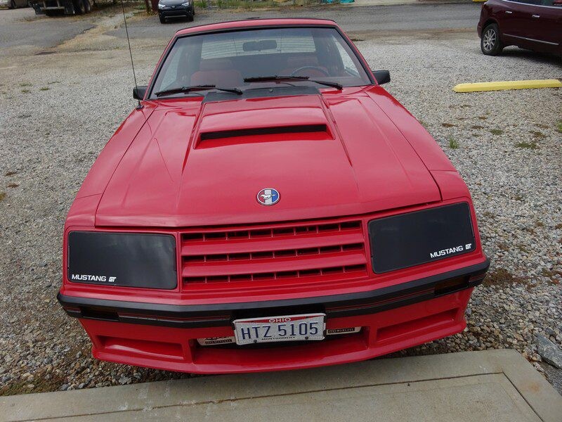 Red Ford Mustang GT front view.