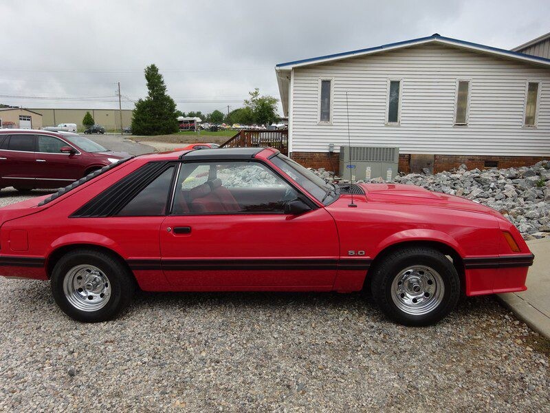 Red Ford Mustang 5.0 GT hatchback.