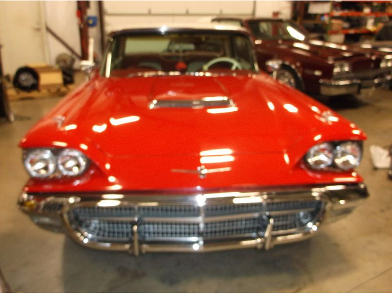 Red classic Ford Thunderbird convertible.