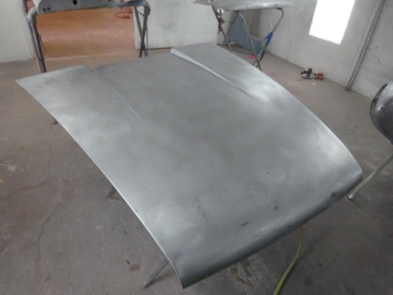 Primed car hood in paint shop.