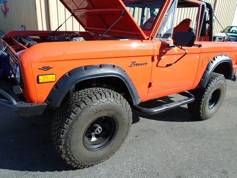 Orange Ford Bronco off-road vehicle.