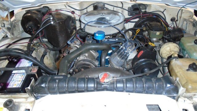 Jeep engine bay with components visible.