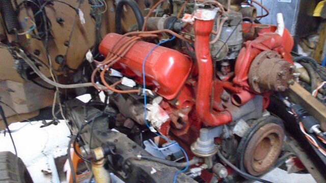 Red engine in classic car during restoration.