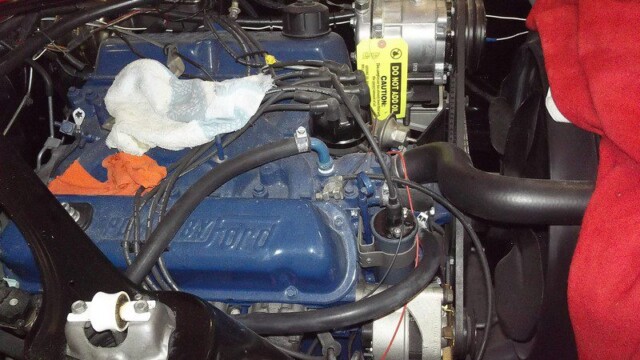 Blue Ford engine with AC compressor.