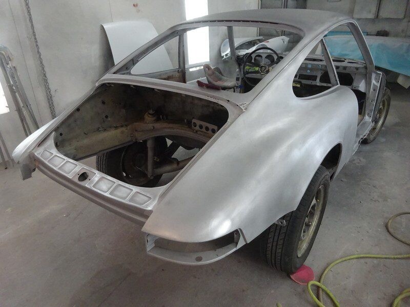 Silver Porsche 911 undergoing restoration.