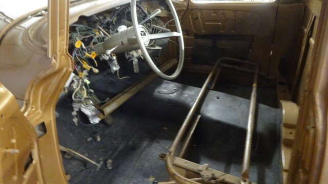 Here's an alt tag for the image: Gold classic truck interior under restoration.