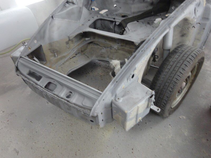 Stripped car body undergoing restoration.