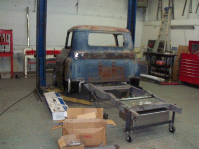 Classic truck chassis restoration in garage.