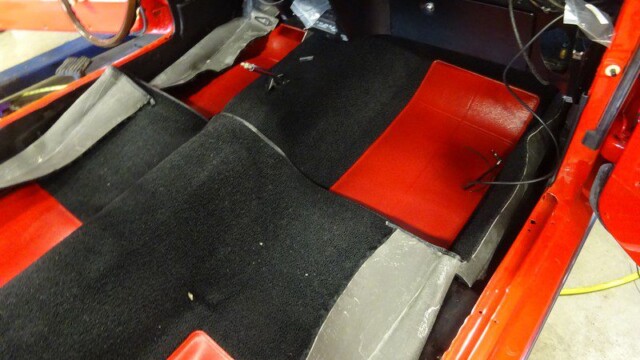 Red car interior with new carpet.