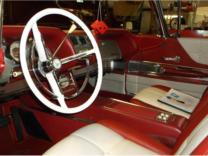 Here's an alt tag for the image: Red and white 1958 Ford Thunderbird interior.