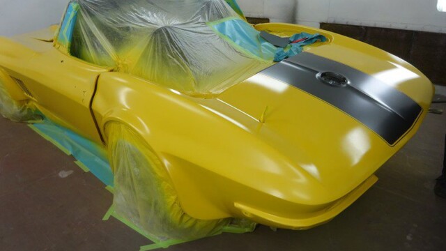 Yellow Corvette convertible, freshly painted.