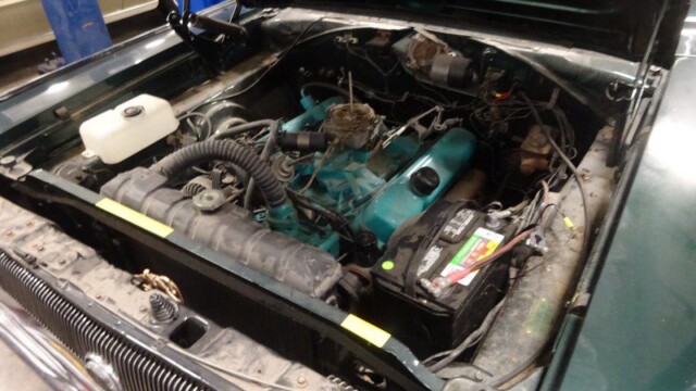 Classic car engine bay, open hood.