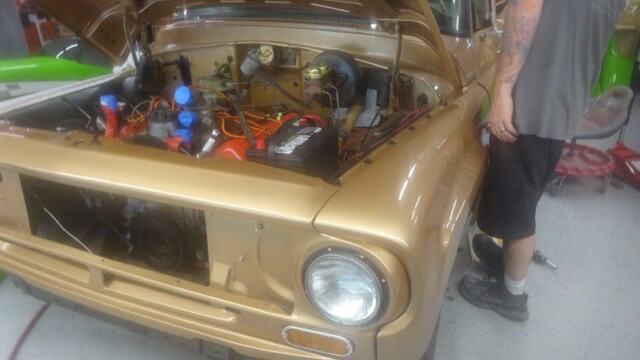 Gold classic car engine bay detail.