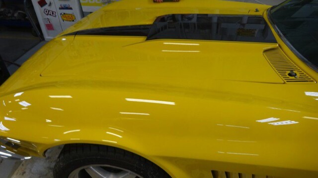 Yellow Corvette Stingray undergoing detailing.