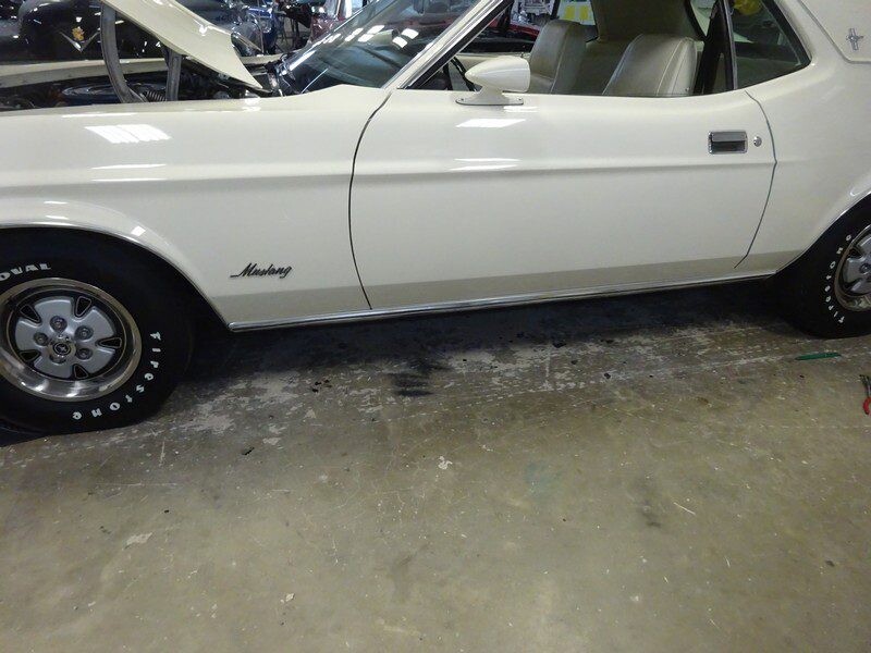 Classic white Ford Mustang coupe.