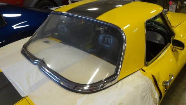 Yellow Corvette convertible rear window detail.