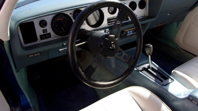 Here's an alt tag for the image: Blue Pontiac Trans Am interior.