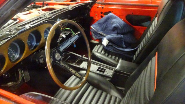 Red classic car interior, under restoration.