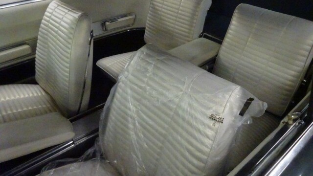 Classic car's interior, white leather seats.