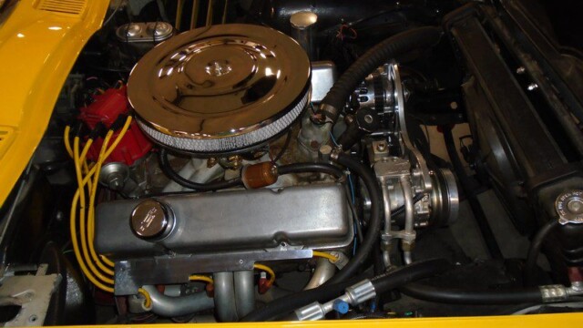 Yellow classic car engine detail.