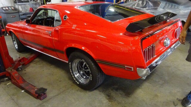 Red Ford Mustang Boss 429 in garage.