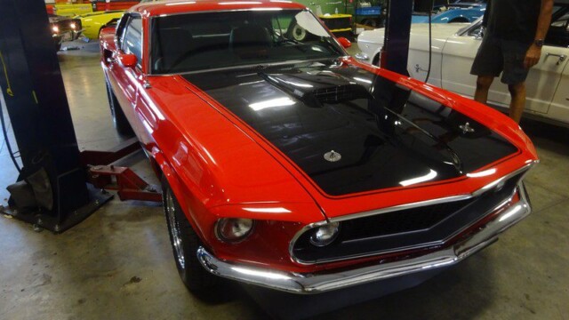 Red Ford Mustang Boss 429 in garage.