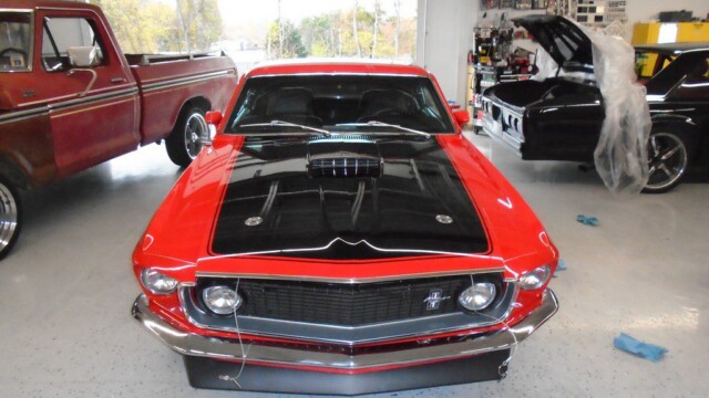 Red Ford Mustang in a garage.