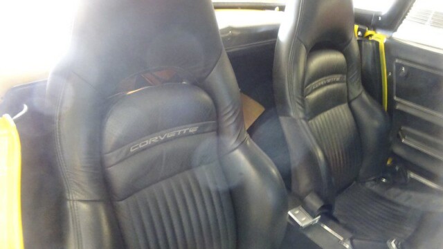 Black leather Corvette seats inside car.