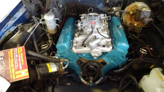 Teal engine bay, classic car detail.