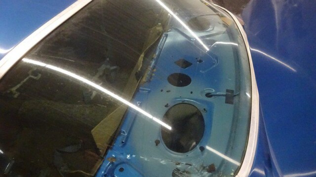 Blue car's rear window and interior.