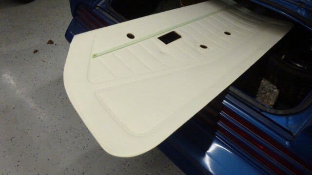 Off-white car trunk panel replacement.