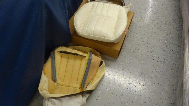 Two damaged vintage car seats.