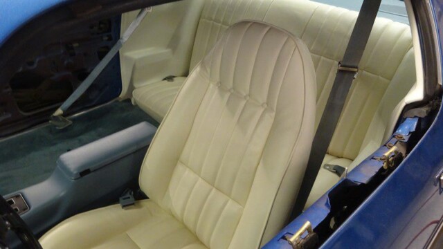 Cream interior of a blue Camaro.