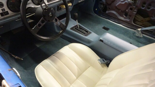 Cream interior of a blue Pontiac Trans Am.