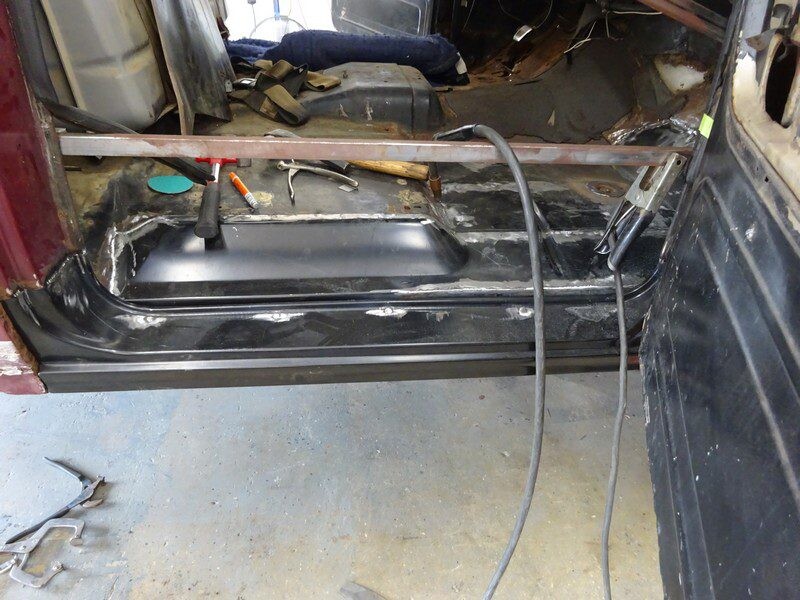 Car body repair, welding in progress.