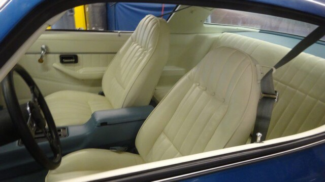 Classic car's cream interior and blue exterior.