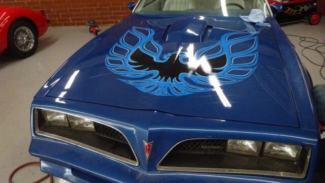 Blue Pontiac Firebird with flame decal.