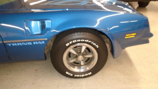 Blue Pontiac Trans Am's front fender.