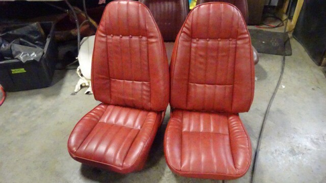 Red vinyl car seats for restoration.