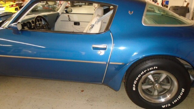 Blue classic muscle car with white interior