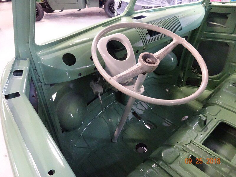Green vintage VW van interior, steering wheel.
