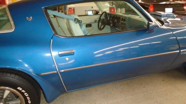 Blue Pontiac Trans Am side profile.