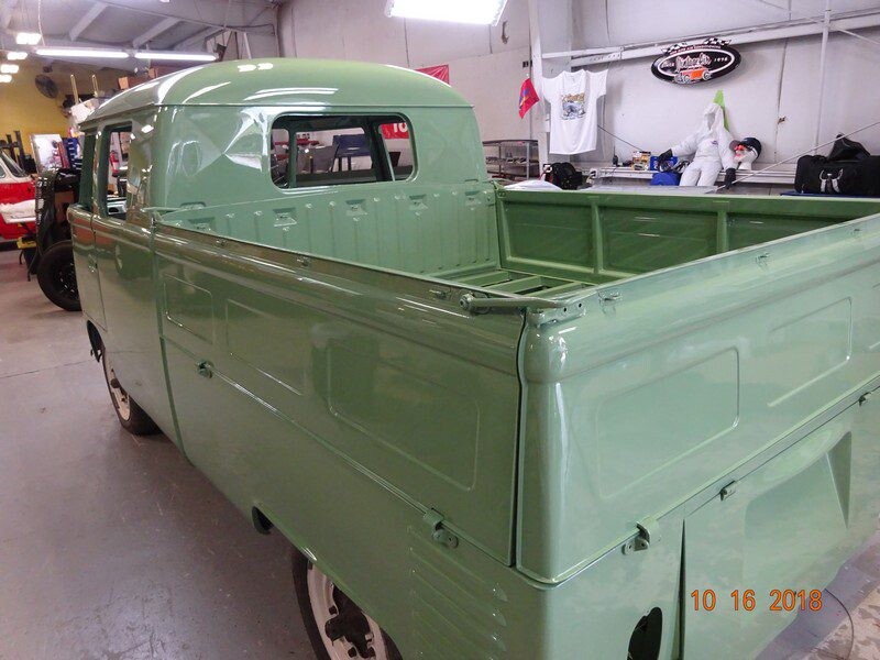 Green vintage Volkswagen pickup truck.